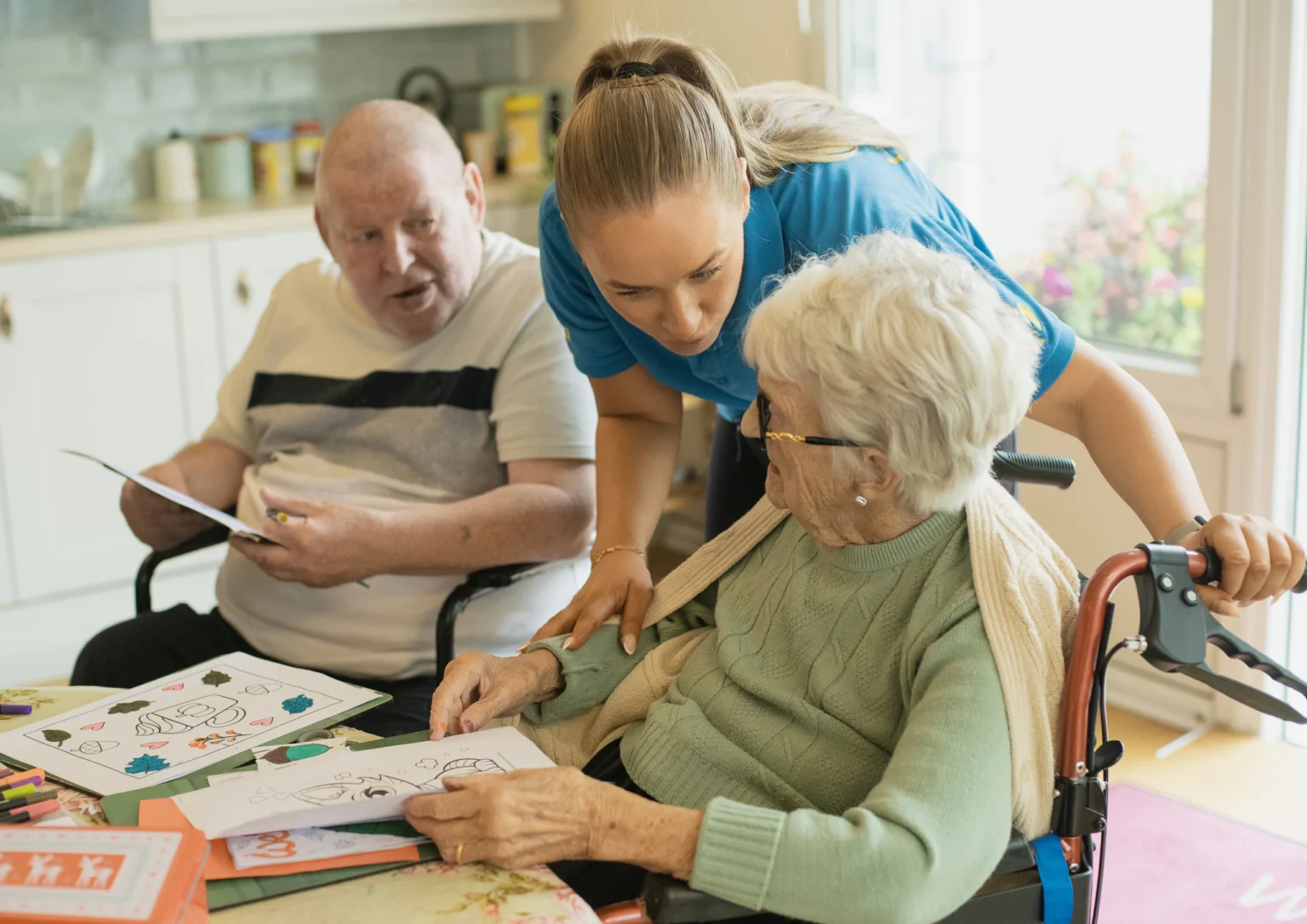 Carer supporting residents with an activity